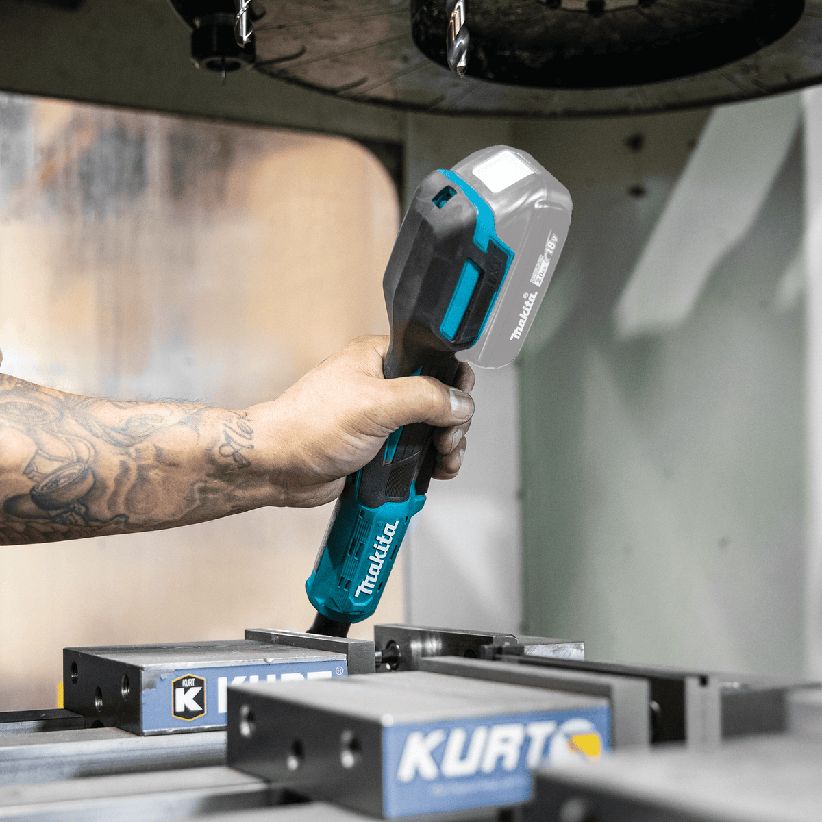 Operator holding the ergonomic rubberized handle of the Makita XRW01Z ratchet during overhead mechanical equipment maintenance.