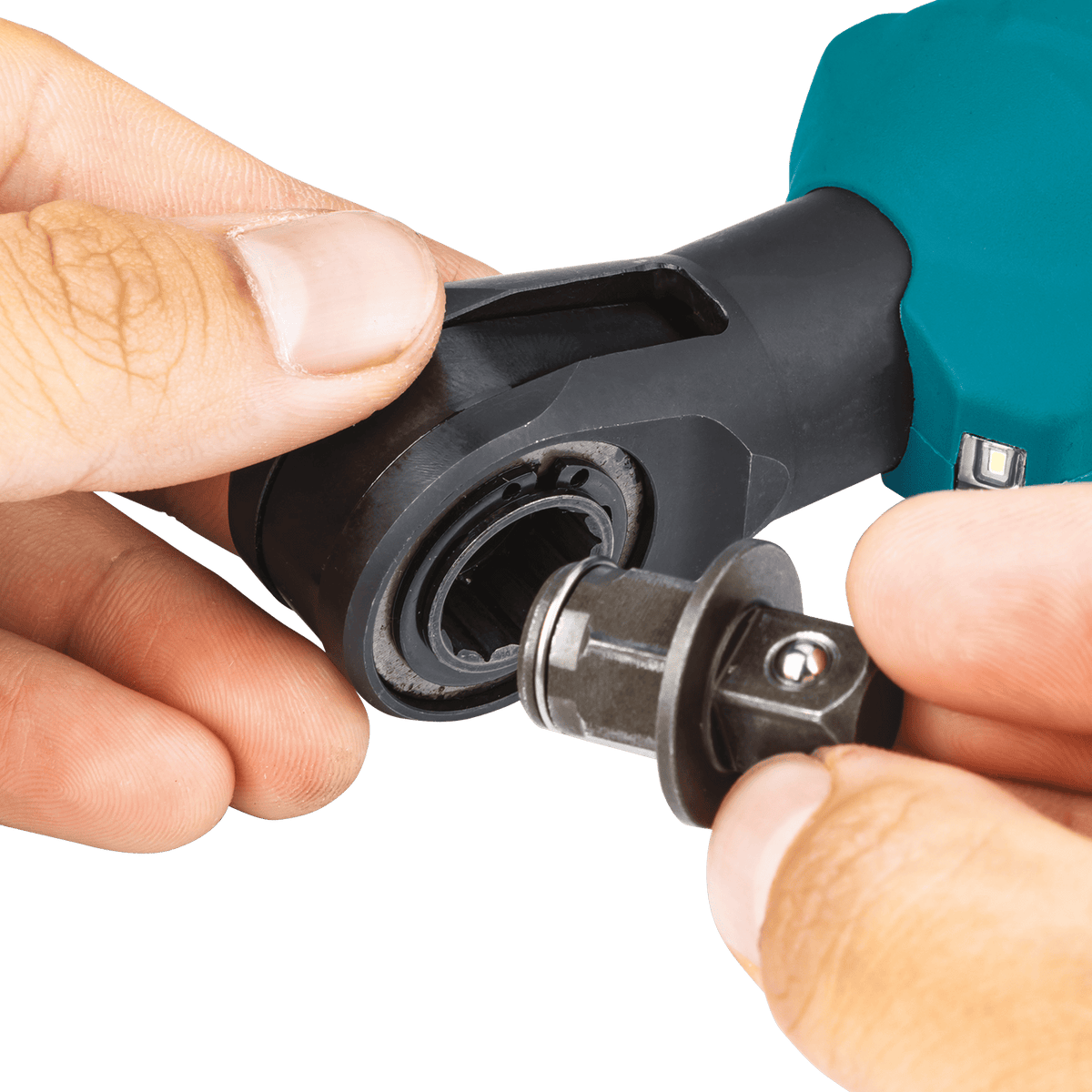 Hands installing an interchangeable square drive anvil adapter into the low-profile head mechanism of the Makita XRW01Z ratchet.
