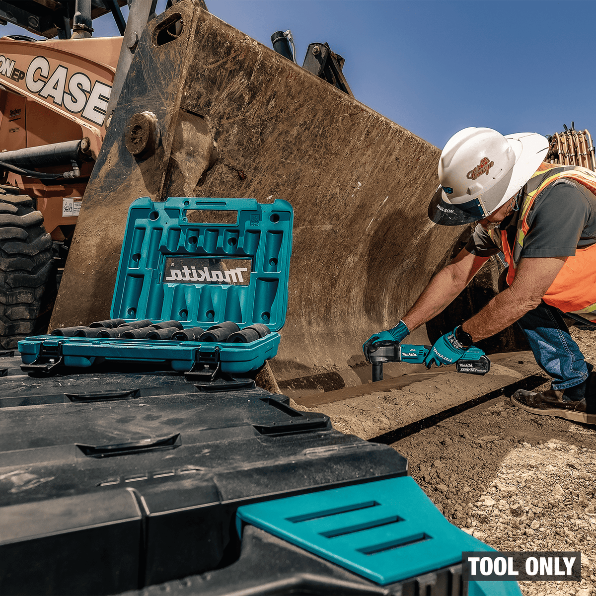 Field mechanic using the Makita XLT05Z cordless angle impact wrench with deep impact sockets on a loader cutting edge.