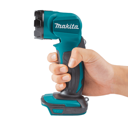 Hand holding the compact Makita DML815 18V flashlight demonstrating its lightweight 1.95-pound balanced design for crawlspace work.