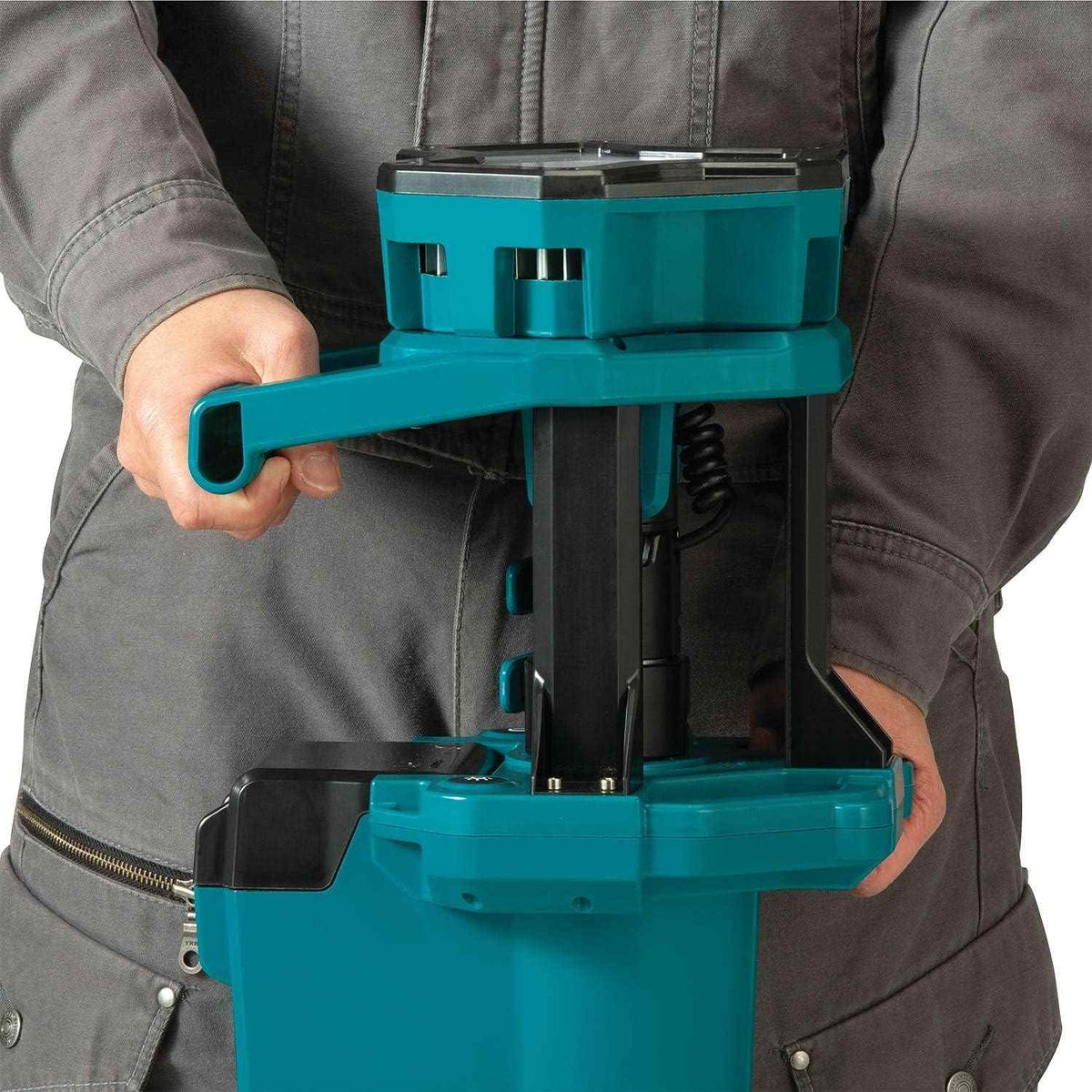 Close-up view of the Makita DML813 center assembly showing the robust carrying handle and the compact way the light head stows when the tripod is folded for storage.
