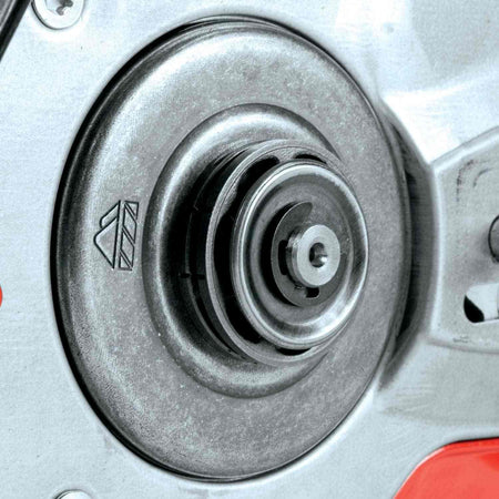 Detailed view of the metal floating rim sprocket and clutch drum mechanism on the side of the chainsaw powerhead.