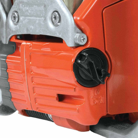 Close-up of the black quick-release tank cap with S-form handle designed for easy opening on the chainsaw body.
