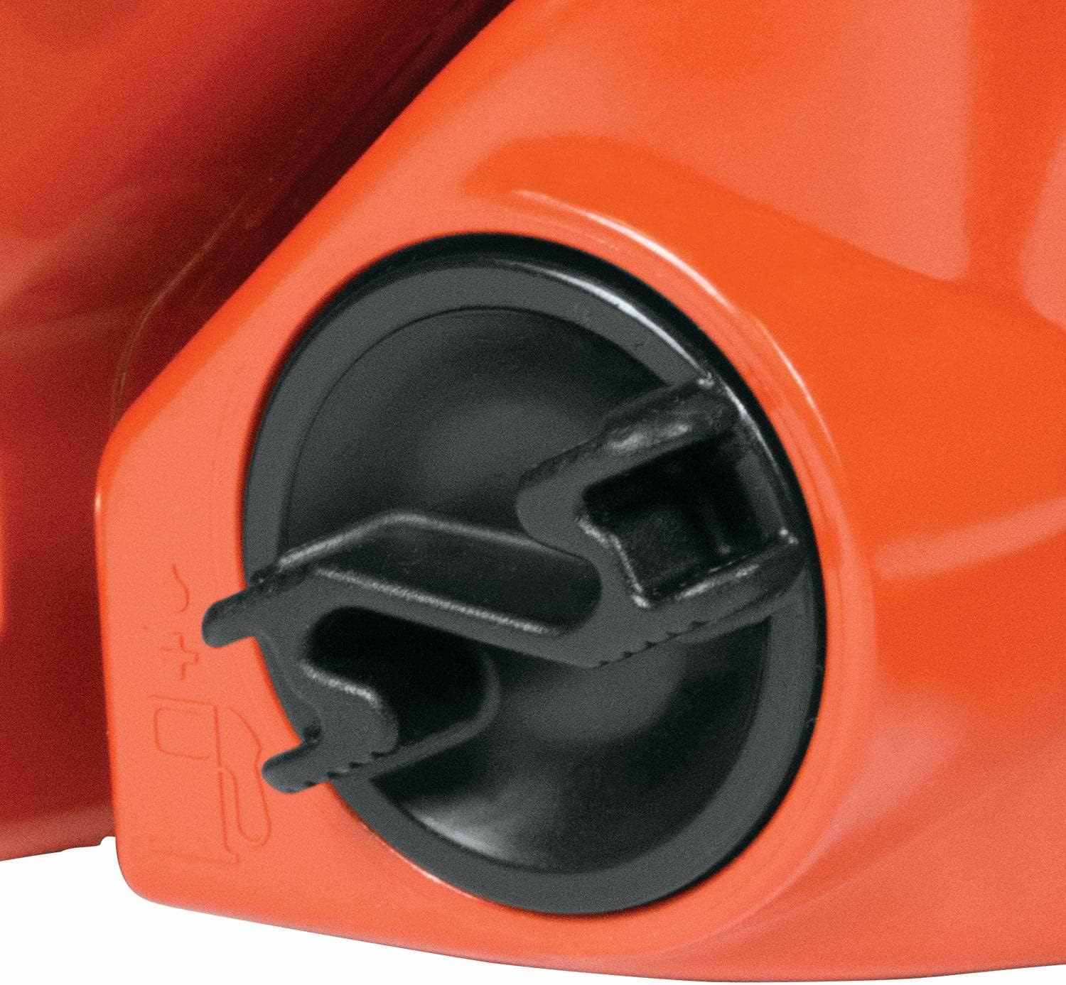Detail view of the black oil tank cap located near the front handle of the orange chainsaw housing.