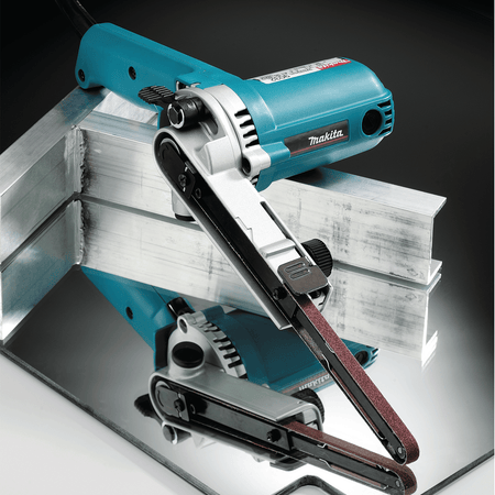 Makita 9032 belt sander with its arm pivoted to clean and blend internal corner weld joints on structural aluminum channel stock.
