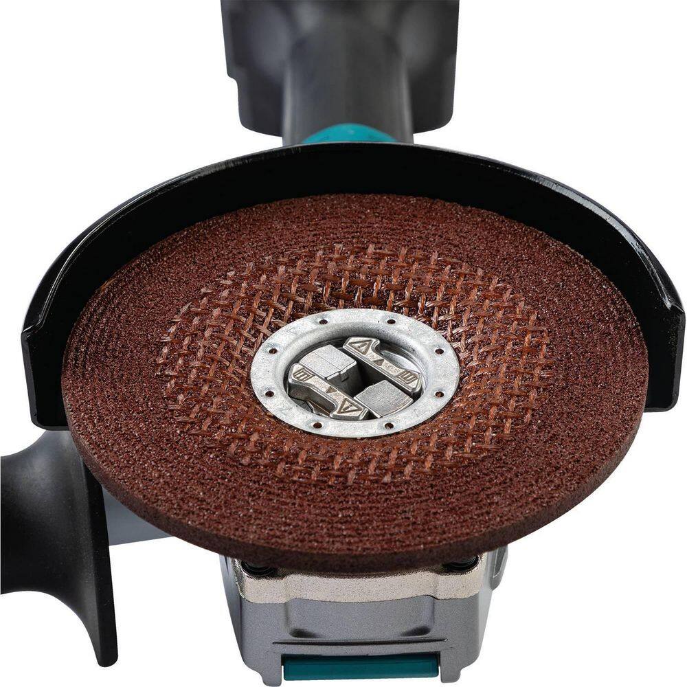 Close-up view of the Makita 40V cordless grinder spindle without an accessory, showcasing the tool-free X-LOCK mounting interface and the adjustable metal safety guard.