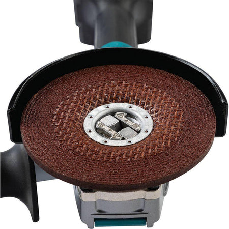 Close-up view of the Makita 40V cordless grinder spindle without an accessory, showcasing the tool-free X-LOCK mounting interface and the adjustable metal safety guard.