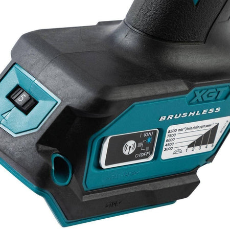 Detailed close-up of the Makita XGT grinder handle showcasing the variable speed control dial with five settings and the Auto-Start Wireless System (AWS) Bluetooth connectivity button.