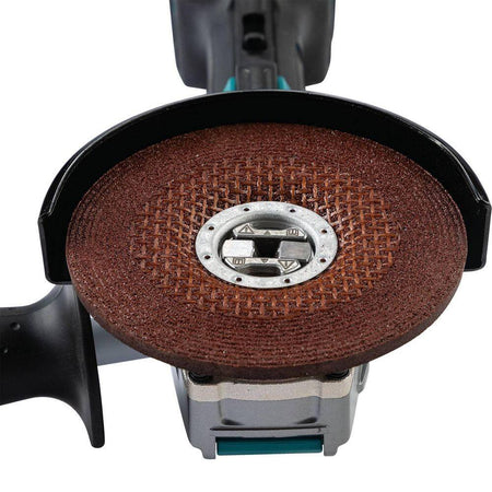 Close-up view of the Makita X-LOCK spindle interface with a 5-inch abrasive wheel clicked into place, illustrating the secure "click-mount" technology that eliminates traditional flange nuts.