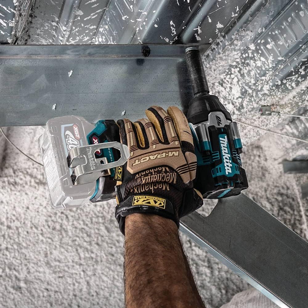 An overhead action shot of a professional wearing heavy duty Mechanix M-Pact gloves operating the Makita GWT08Z 40V Max XGT mid torque cordless impact wrench. The mechanic tool is outfitted with a deep impact socket and is being used to securely fasten structural steel overhead beams.