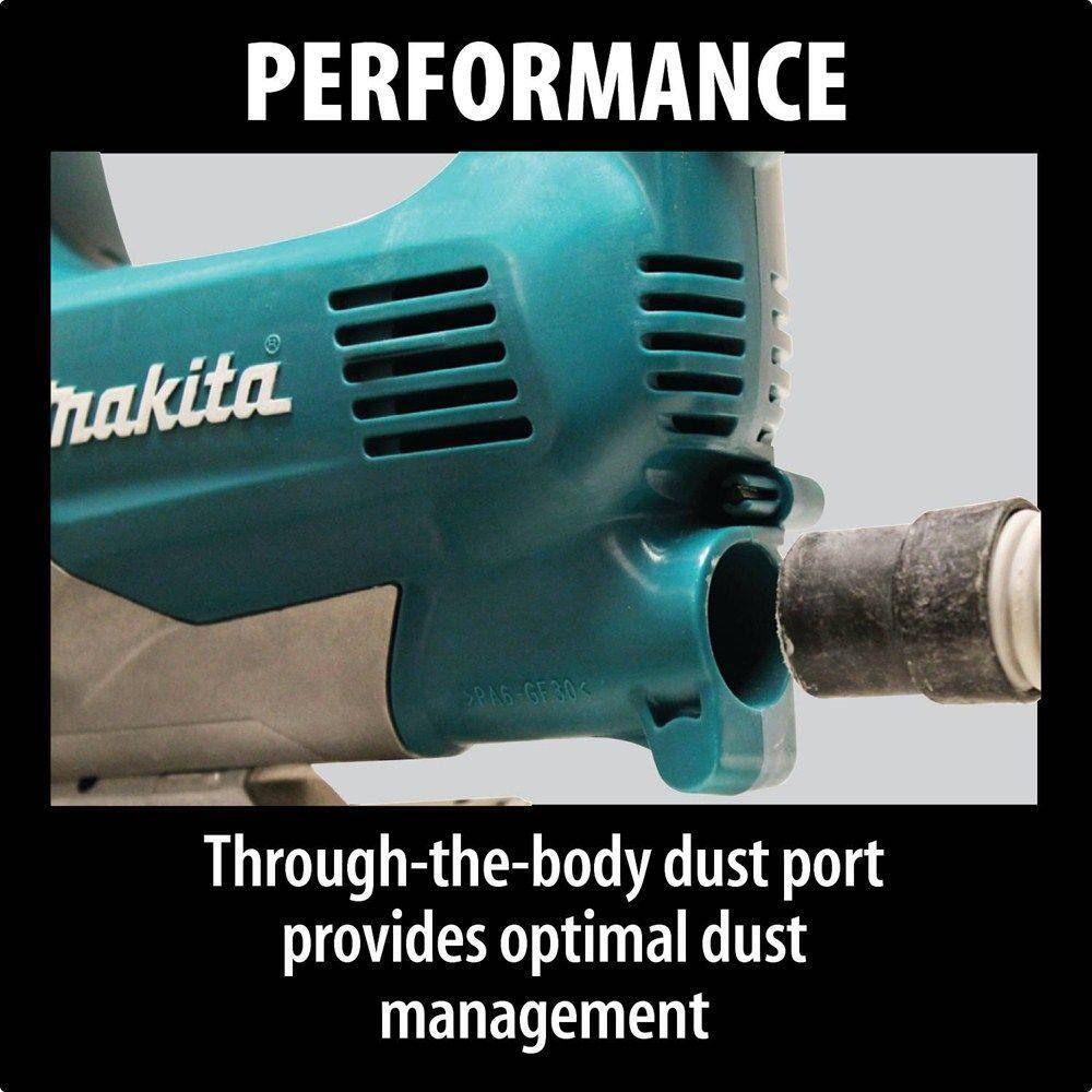 Underside view of the Makita jig saw displaying the precision metal base plate and the through-the-body dust port designed for efficient dust management when connected to a vacuum.