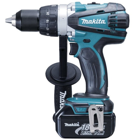 Side profile view of the teal and black Makita 18V cordless driver-drill with an attached auxiliary side handle and battery pack, displaying the keyless chuck and numbered torque adjustment ring.