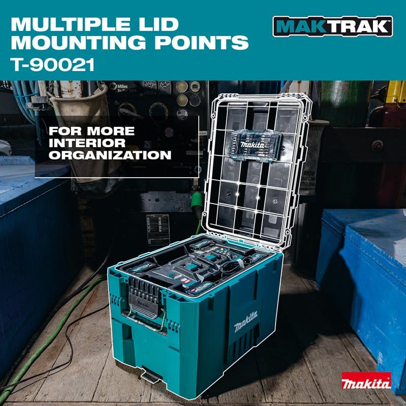 Application shot of the Makita T-90021 tool box on an industrial jobsite, showing the open lid with highlighted mounting points and the interior containing power tool batteries and a charger.