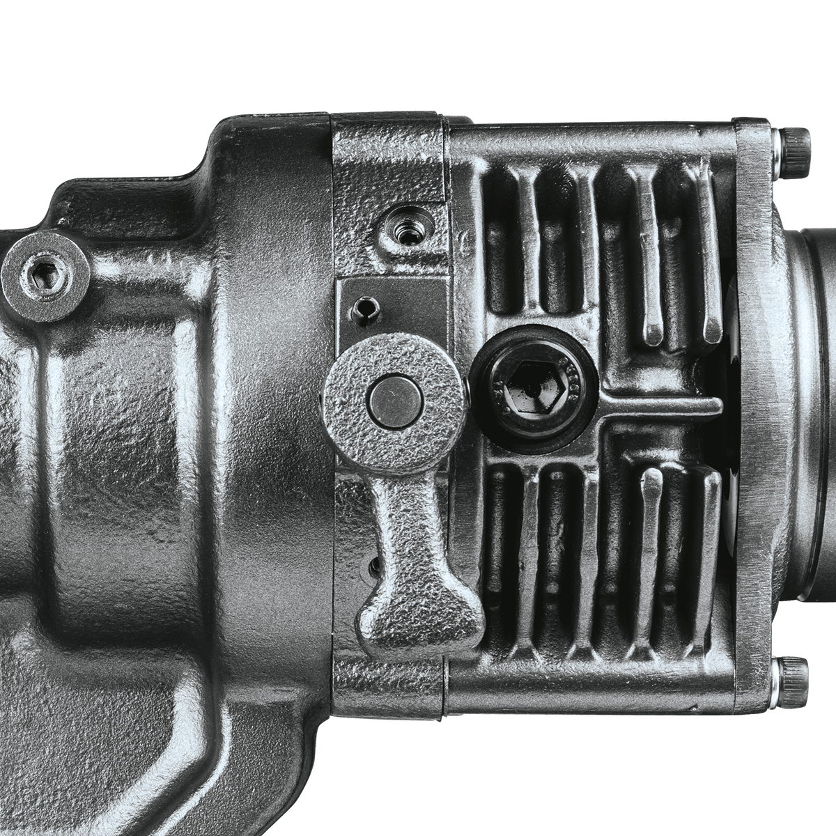 Close-up view of the manual return lever used to retract the punching die mid-operation on the metal punch housing.