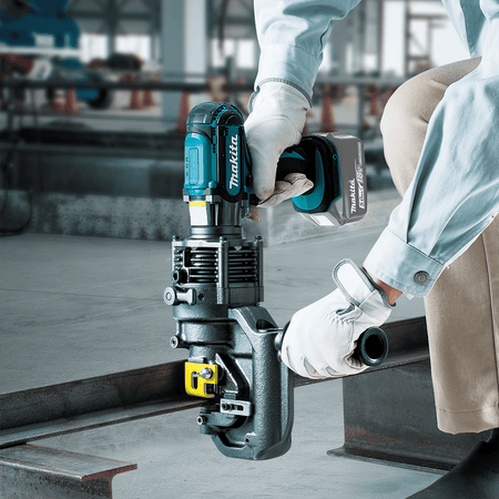 Ironworker using the Makita 18V cordless hole puncher to punch a clean hole through a structural steel beam flange.
