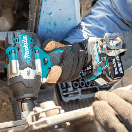Operator tightening a chassis fastener with the compact 6-11/16-inch Makita XWT17 brushless mid-torque impact wrench.
