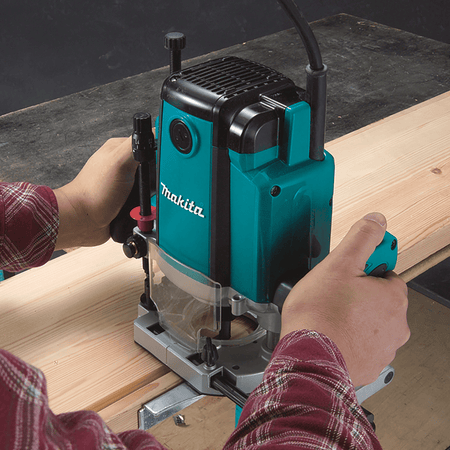Craftsman using Makita RP1800 plunge router with parallel fence to mill straight dado grooves into lumber stock.