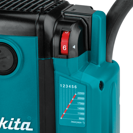 Detailed view of the 6-speed variable control thumb dial on the Makita RP2301FC router for material speed matching.
