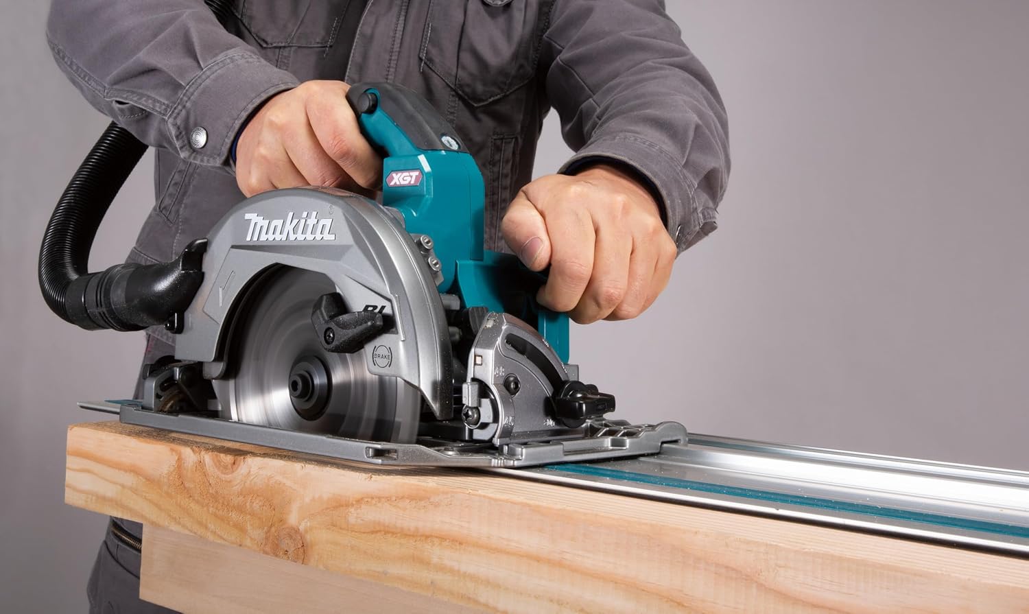Makita XGT circular saw mounted on a 194368-5 guide rail performing a clean bevel cut on dimensional timber without tear-out.