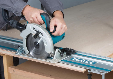 Standard circular saw fitted with a guide rail adapter ripping plywood on a Makita 194368-5 aluminum track.