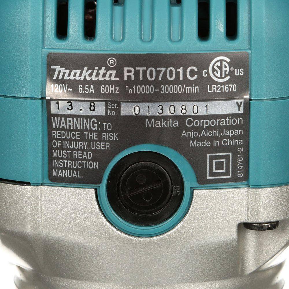 Close-up of the specification label on the Makita RT0701CX3 1-1/4 HP variable speed compact router motor, displaying the 6.5 Amp power rating and 10,000 to 30,000 RPM speed range.