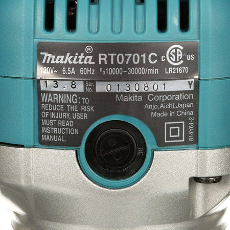 Close-up of the specification label on the Makita RT0701CX3 1-1/4 HP variable speed compact router motor, displaying the 6.5 Amp power rating and 10,000 to 30,000 RPM speed range.