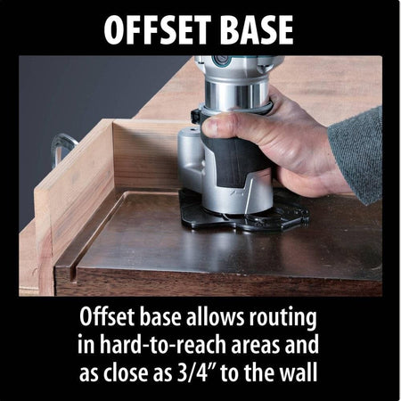 Close-up action shot of a woodworker using the Makita offset base attachment for the RT0701CX3 compact router to make precision woodworking cuts in tight, hard-to-reach areas close to a wall.