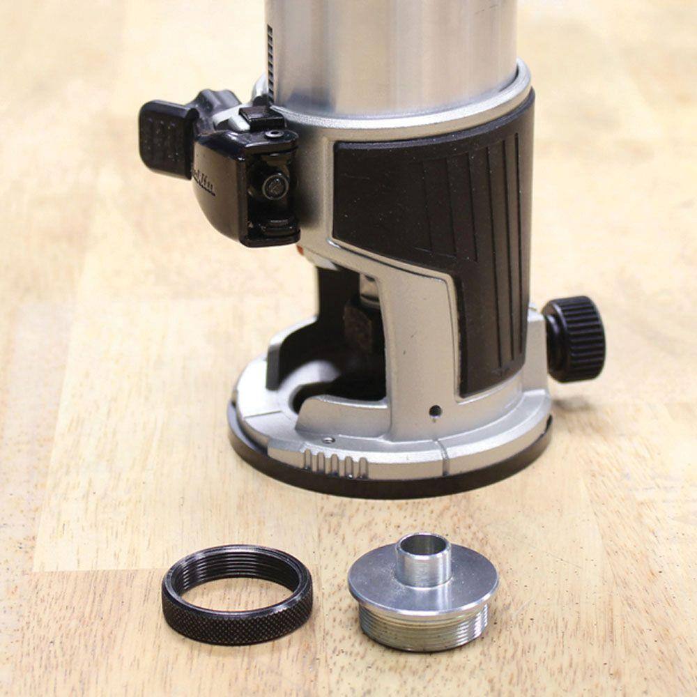 The Makita RT0701CX7 router motor securely mounted in the fixed base, shown next to an industry standard template guide adapter.