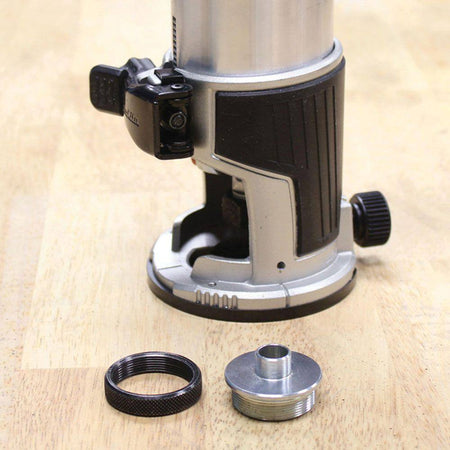 The Makita RT0701CX7 router motor securely mounted in the fixed base, shown next to an industry standard template guide adapter.