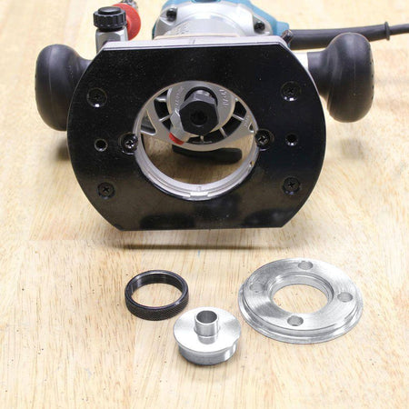 Bottom view of the Makita RT0701CX7 router's fixed base revealing the 1/4 inch collet alongside an industry standard template guide insert.