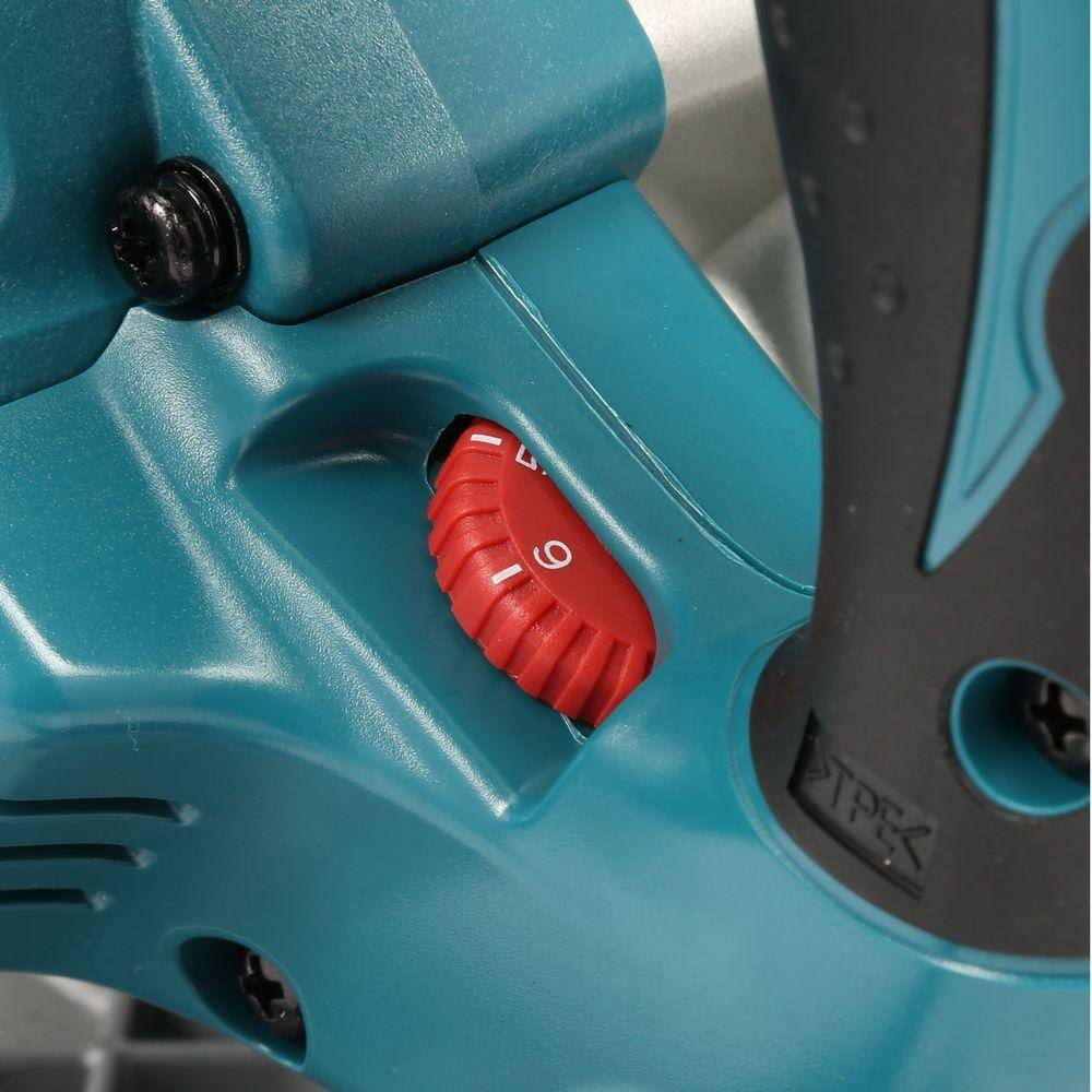 Close-up of a blue power tool with a red switch