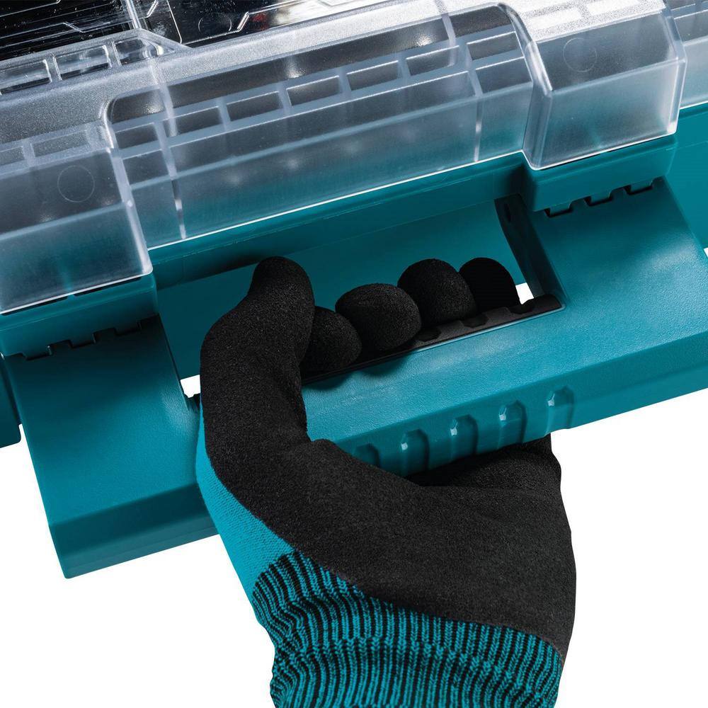 Close-up action shot of a gloved hand using the robust comfort-grip carrying handle of the Makita T-90043, highlighting the ergonomic design for transporting heavy tool and hardware loads.