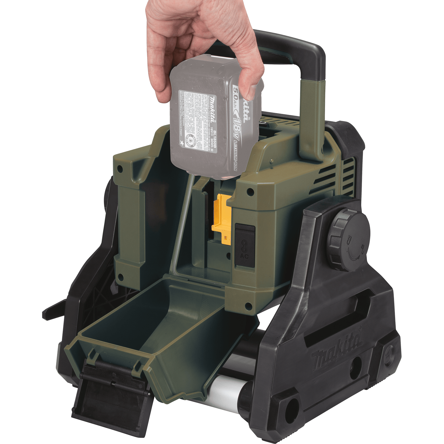 Hand inserting a 5.0Ah 18V LXT lithium-ion battery into the rear weather-sealed battery compartment of the Makita ADML811 area floodlight.