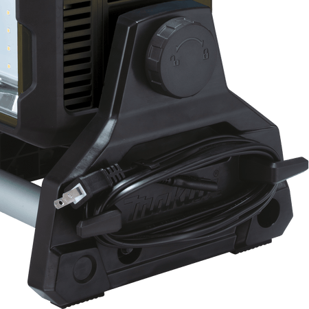 Close-up of the side frame wrap on the Makita ADML811 work light neatly stowing the detachable 120V AC power cord.