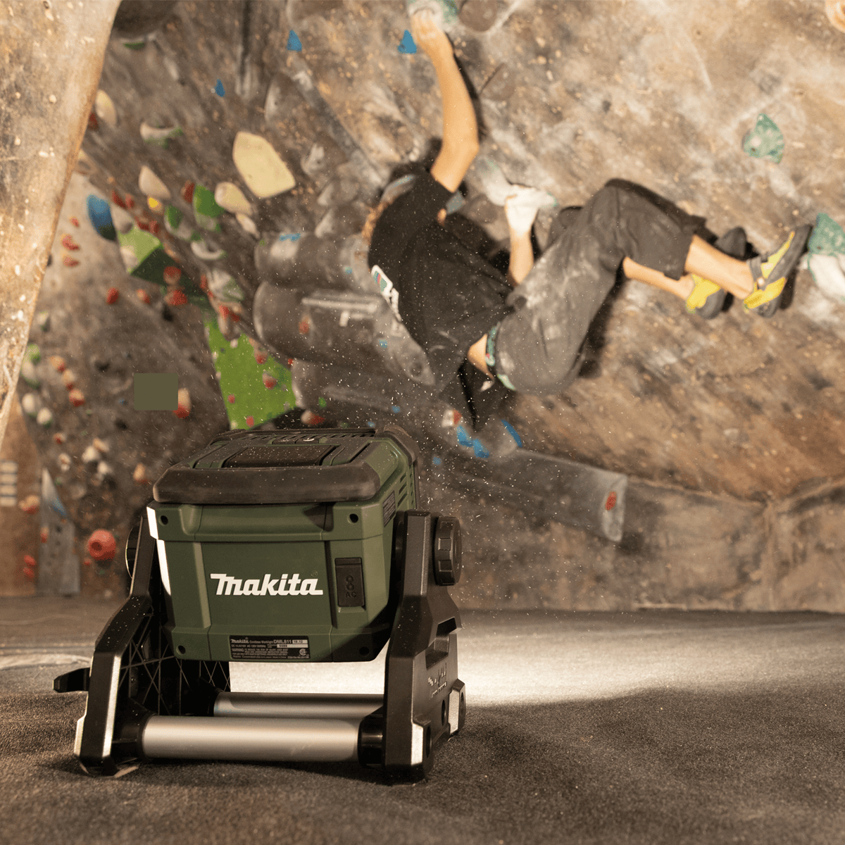 Makita ADML811 cordless area light illuminating an indoor bouldering wall for nighttime athletic training and outdoor recreation.