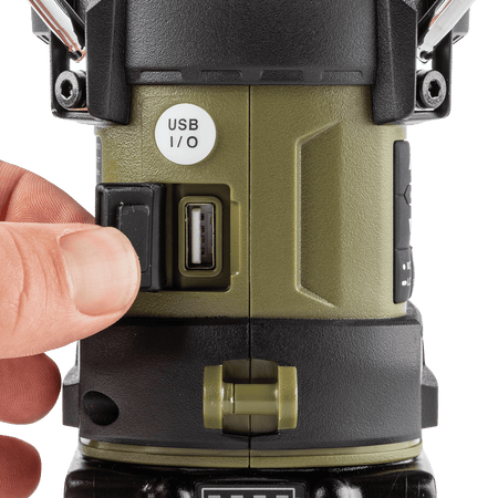 Close-up of the weather-sealed USB Type-A output port on the Makita ADRM13 lantern for charging smartphones and electronic devices.