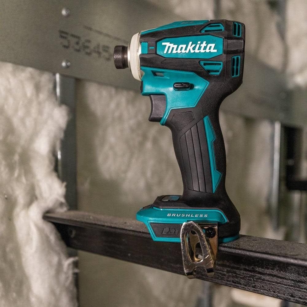 The Makita XDT19Z 18V LXT brushless impact driver shown in a jobsite environment, highlighting its rugged build quality and ergonomic grip for professional construction use.
