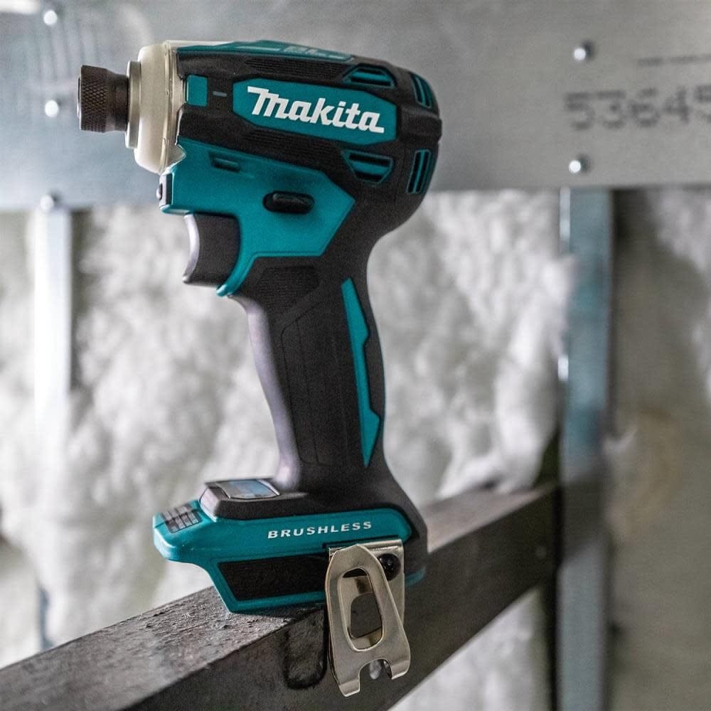 A side perspective of the Makita XDT19Z impact driver positioned on a structural metal beam, showcasing its compact form factor and professional teal finish.