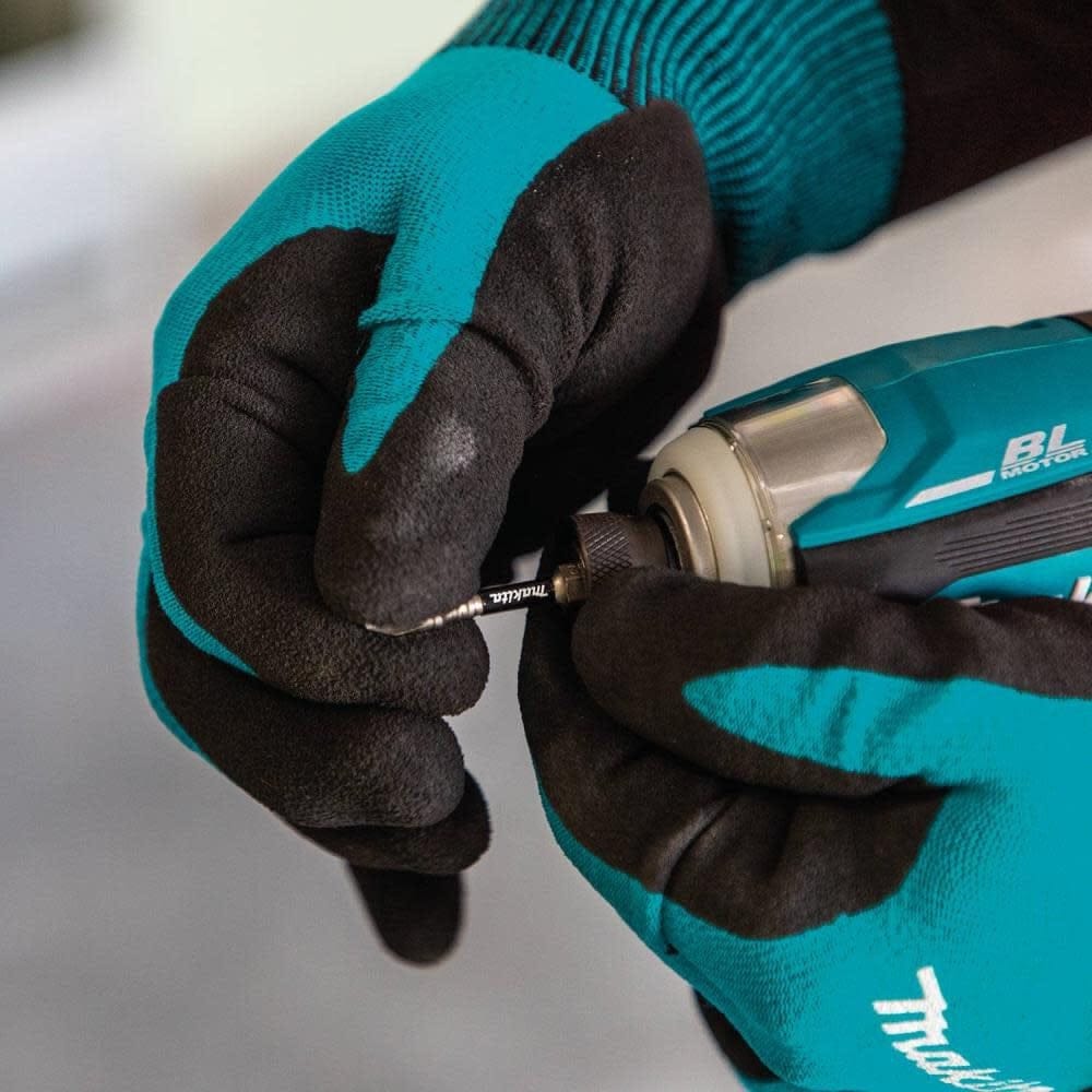 A close-up action shot of gloved hands inserting a fastener into the 1/4 inch one-touch hex chuck of the Makita XDT19Z impact driver for a quick bit change.