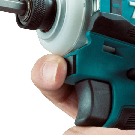 A detailed shot of a user's finger utilizing the one-touch speed selector button located conveniently under the chuck of the Makita XDT19Z brushless impact driver for quick one-handed adjustments.