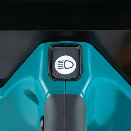 A close-up of the separate on/off switch for the built-in LED light located on the handle of the Makita XEC01Z power cutter.