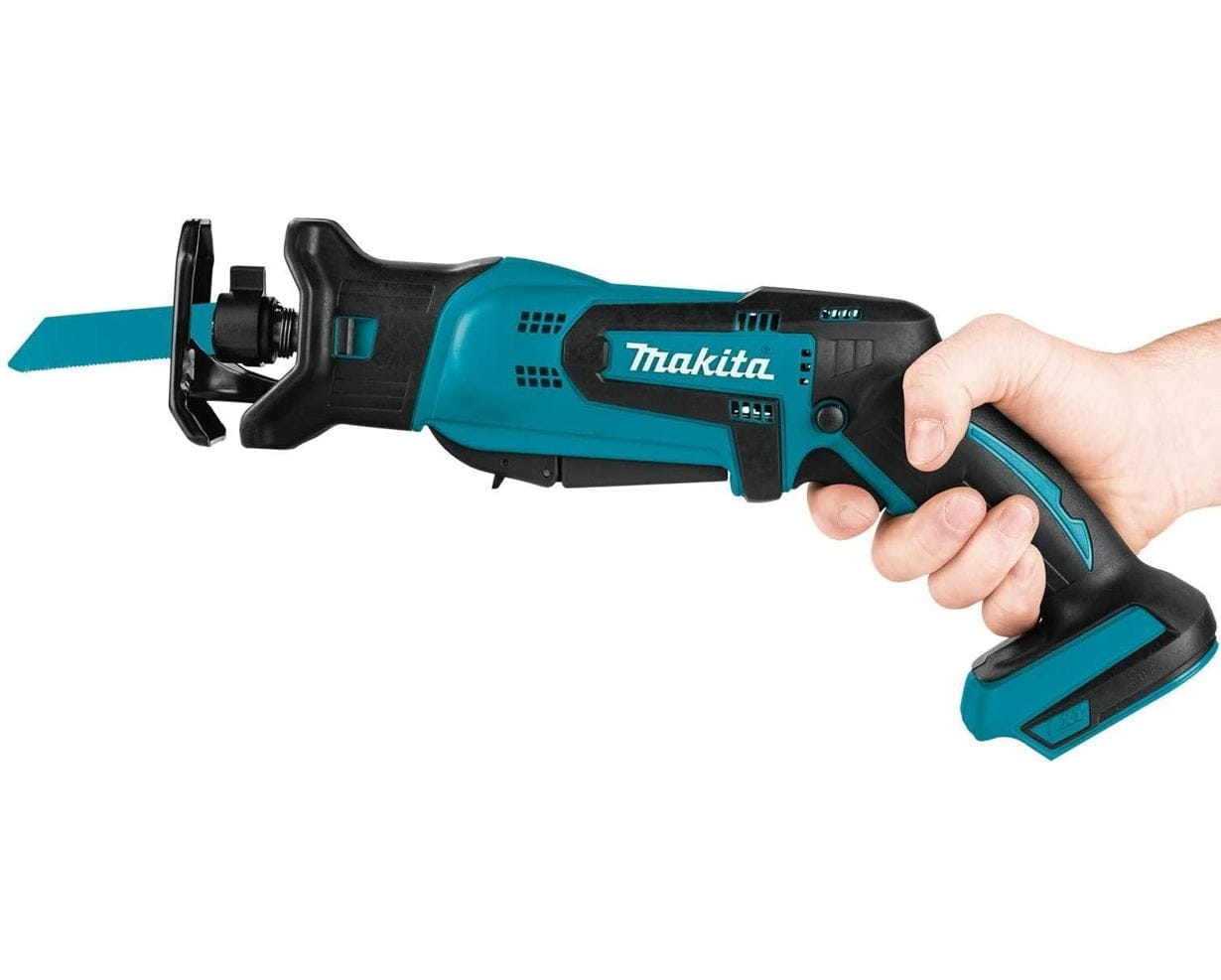 A hand firmly gripping the Makita XRJ01Z 18V LXT cordless compact reciprocating saw, demonstrating the comfortable ergonomic hold and easy access to the dual-position switch.