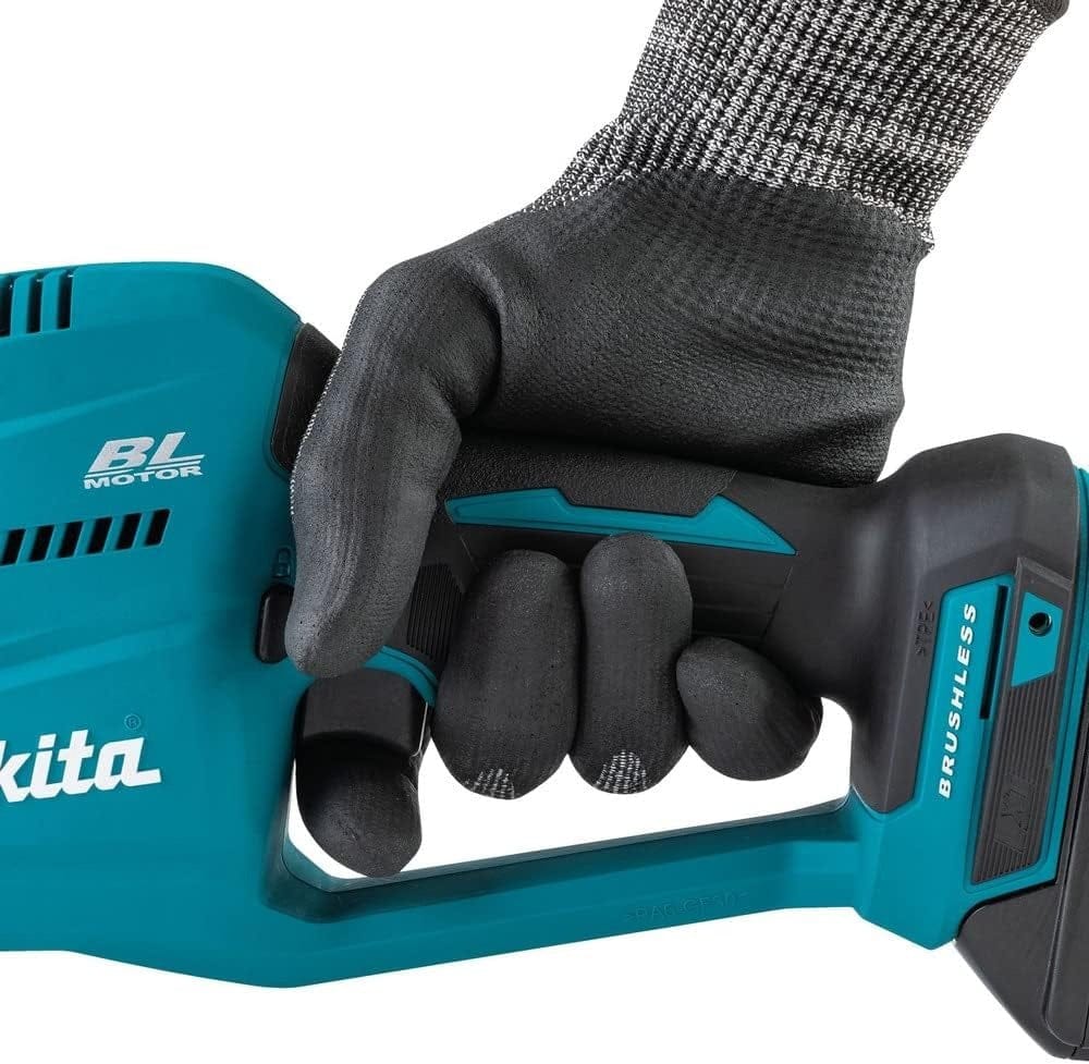 Close-up detail view of a gloved hand gripping the ergonomic rubberized handle of the Makita reciprocating saw.
