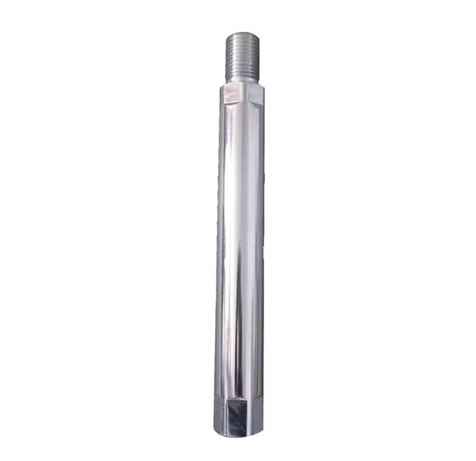 The image shows a silver, cylindrical Milwaukee core bit extension. It has threading at the top and a hexagonal base with openings at the bottom.