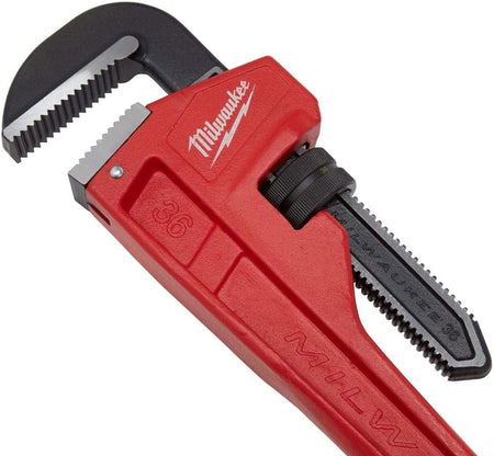 Close-up of the jaw and adjustment knob area of the red Milwaukee pipe wrench, clearly showing the sharp, hardened teeth and the Milwaukee logo stamped on the head.