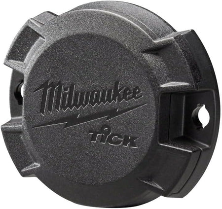 Angled studio shot of the black Milwaukee TICK tool tracker displaying its rugged housing and integrated mounting flanges.