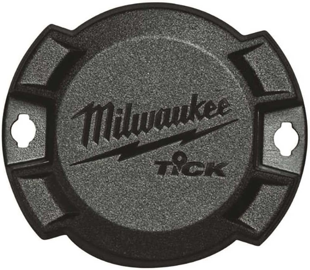 Top-down close-up view of the circular black Milwaukee TICK tracker showing the textured surface, logo, and side mounting holes.