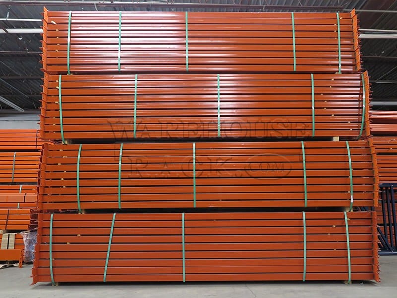 A front-facing view of high-capacity industrial orange teardrop load beams stacked and bundled for warehouse pallet rack systems, showcasing the 144-inch length and 4.5-inch face.