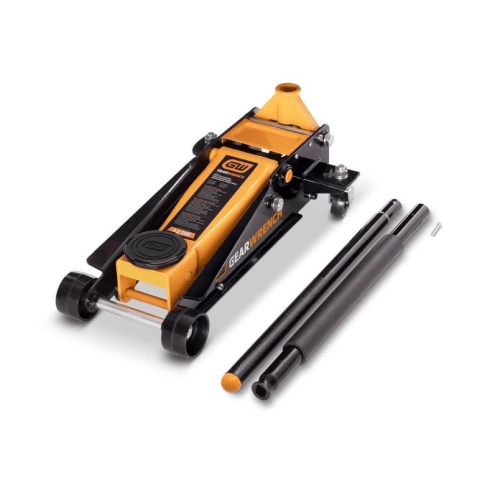 image of 3 Ton Heavy-Duty Floor Jack. This image shows a heavy-duty orange and black floor jack, designed for lifting vehicles, positioned on a white surface. The jack features sturdy wheels, a long body with "GEARWRENCH 3 TON" branding, and a two-piece black handle lying disassembled next to it, indicating its robust construction and portability.