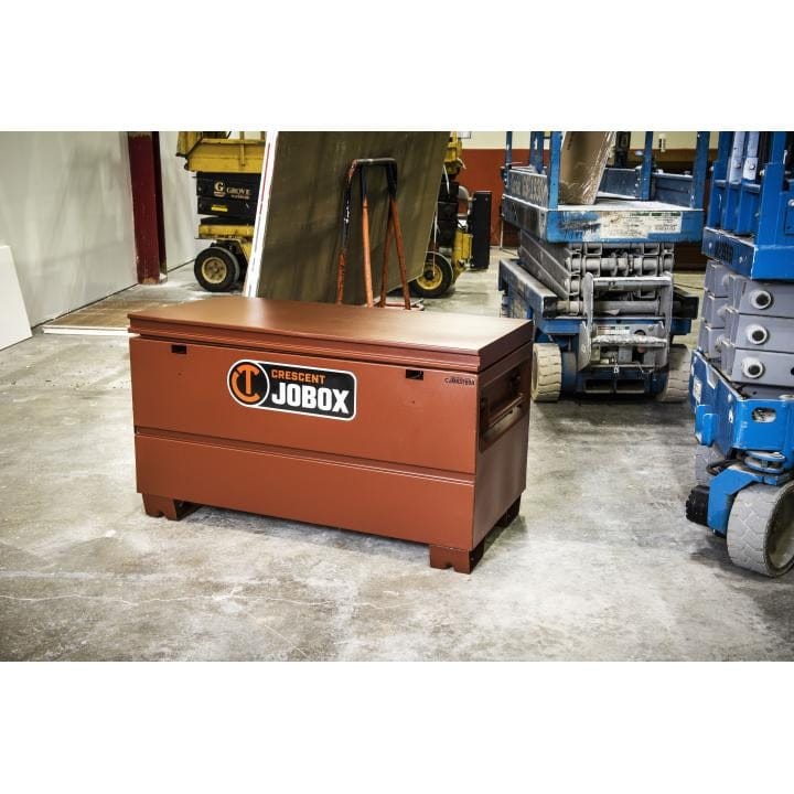 Crescent JOBOX chest in active jobsite with scissor lift and equipment, showing rugged industrial use.